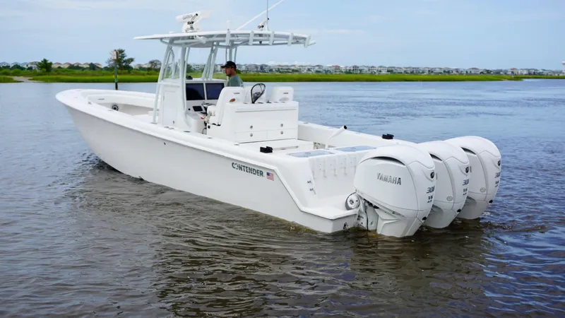  Yacht Photos Pics 2023 Contender 35 ST boat with triple Yamaha engines on calm water.