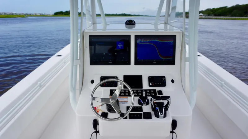  Yacht Photos Pics 2023 Contender 35 ST boat dashboard with dual screens and steering wheel on open water.