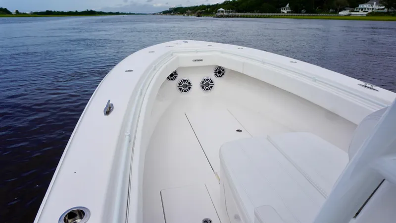  Yacht Photos Pics 2023 Contender 35 ST boat on calm water, showcasing spacious deck and sleek design.