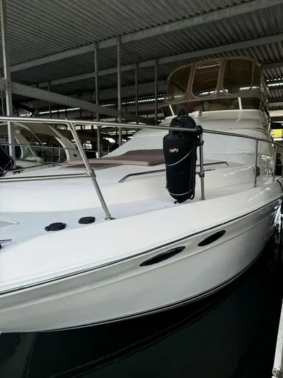  Yacht Photos Pics 1996 Sea Ray 400 Sedan Bridge yacht docked in covered marina.