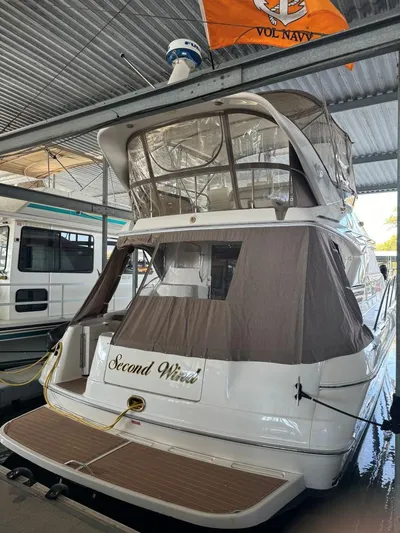  Yacht Photos Pics 1996 Sea Ray 400 Sedan Bridge docked under shelter, featuring "Second Wind" name.