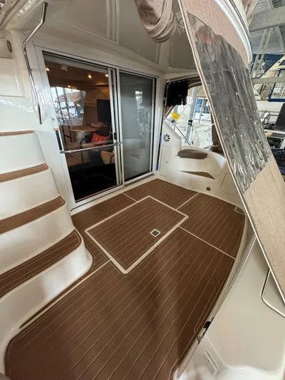  Yacht Photos Pics 1996 Sea Ray 400 Sedan Bridge yacht interior with wooden flooring and sliding glass doors.