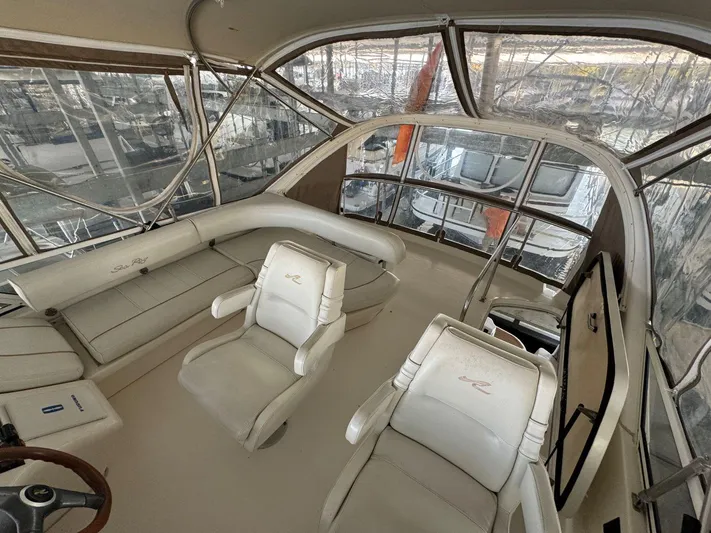  Yacht Photos Pics 1996 Sea Ray 400 Sedan Bridge interior with helm and seating area.