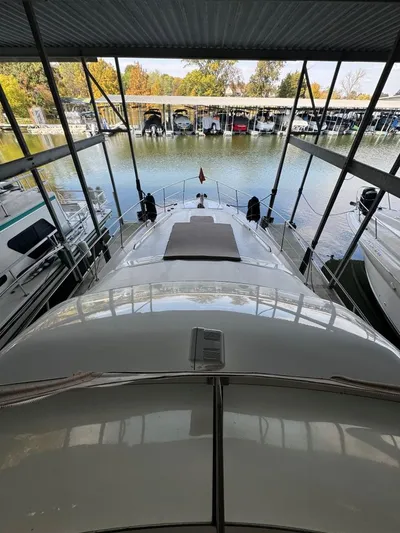  Yacht Photos Pics 1996 Sea Ray 400 Sedan Bridge docked in a marina under a covered slip.