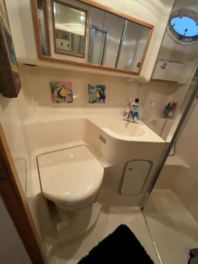  Yacht Photos Pics Bathroom interior of 1996 Sea Ray 400 Sedan Bridge yacht, featuring modern fixtures and decor.
