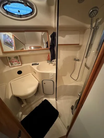  Yacht Photos Pics 1996 Sea Ray 400 Sedan Bridge bathroom with shower, sink, and porthole window.