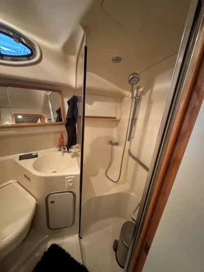  Yacht Photos Pics Bathroom interior of 1996 Sea Ray 400 Sedan Bridge yacht, featuring shower and sink.
