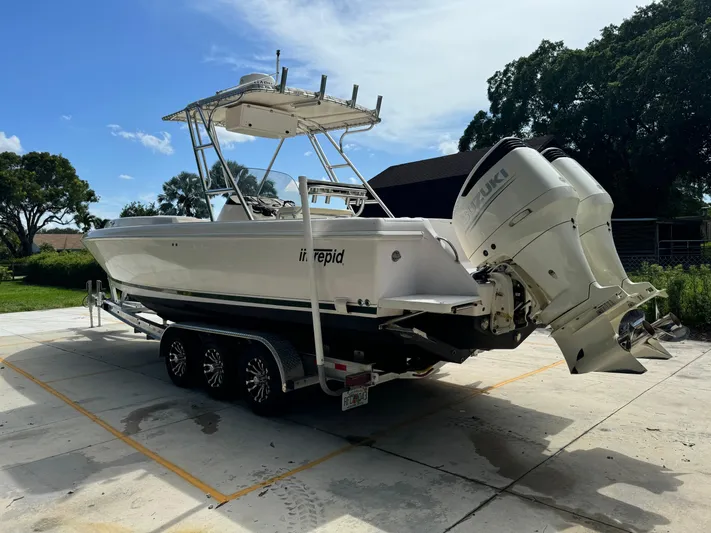  Yacht Photos Pics 2001 Intrepid 327 Center Console boat on trailer, parked outdoors.