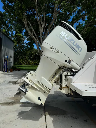  Yacht Photos Pics 2001 Intrepid 327 Center Console with Suzuki outboard motor, parked outdoors.