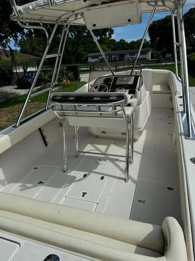  Yacht Photos Pics 2001 Intrepid 327 Center Console boat interior with helm and seating, showcasing spacious deck layout.