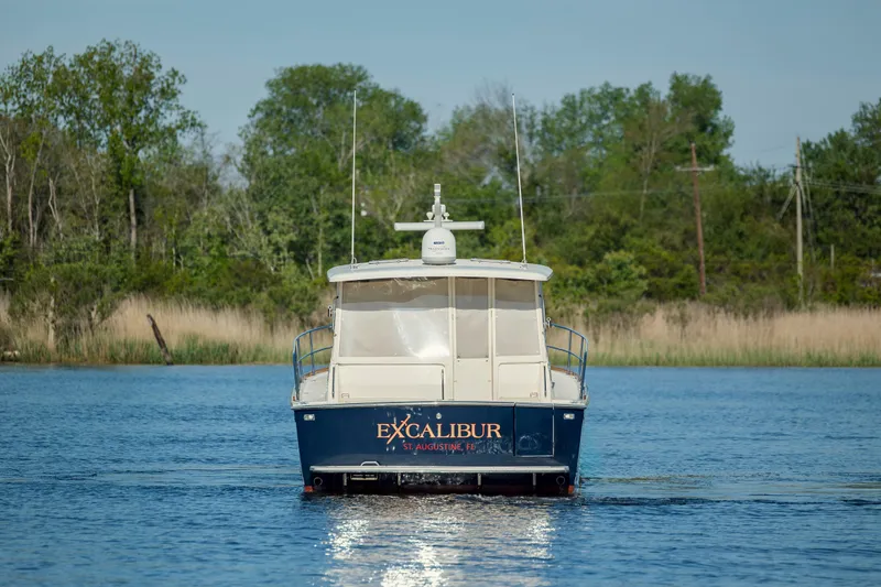  Yacht Photos Pics 2009 Sabre 42 Express boat named Excalibur on a calm lake.
