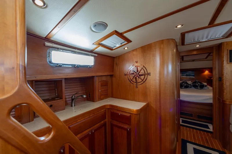  Yacht Photos Pics Luxurious 2009 Sabre 42 Express yacht interior with wood finish and compass wall design.