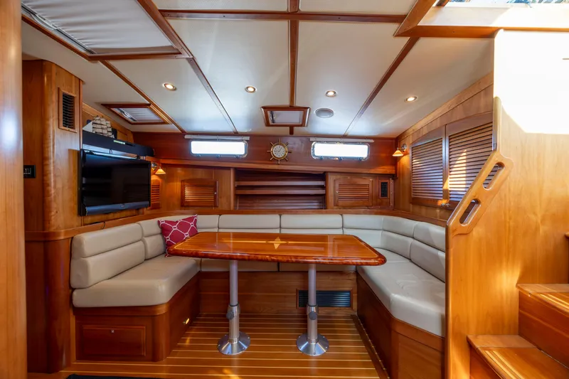  Yacht Photos Pics Luxurious interior of 2009 Sabre 42 Express yacht with wood finish and cozy seating area.