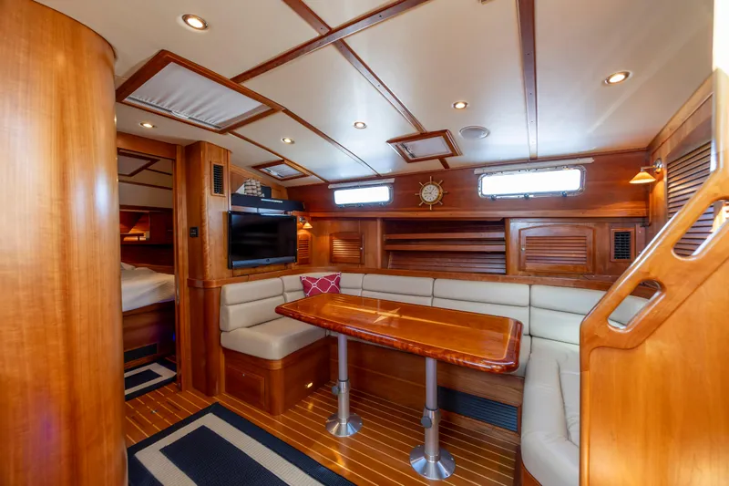  Yacht Photos Pics Luxurious interior of 2009 Sabre 42 Express yacht with wood finish and cozy seating area.
