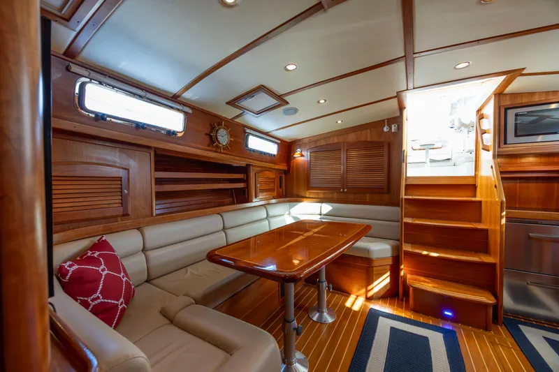  Yacht Photos Pics Luxurious interior of 2009 Sabre 42 Express yacht with wooden finishes and cozy seating area.