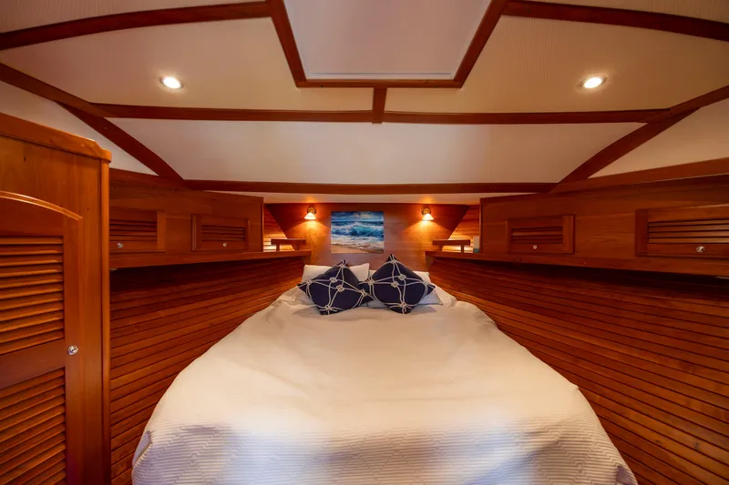  Yacht Photos Pics Luxurious 2009 Sabre 42 Express cabin with cozy bed and elegant wood paneling.