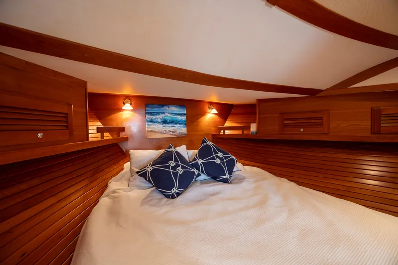  Yacht Photos Pics Cozy cabin interior of 2009 Sabre 42 Express yacht with wooden finish and nautical decor.