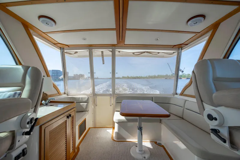  Yacht Photos Pics Interior of 2009 Sabre 42 Express yacht with seating and table, overlooking water.