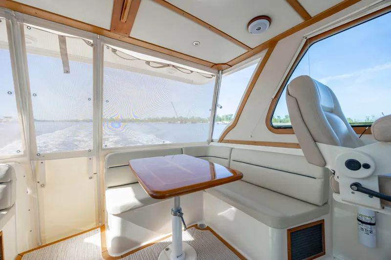  Yacht Photos Pics Interior of 2009 Sabre 42 Express yacht with seating and table, featuring large windows.