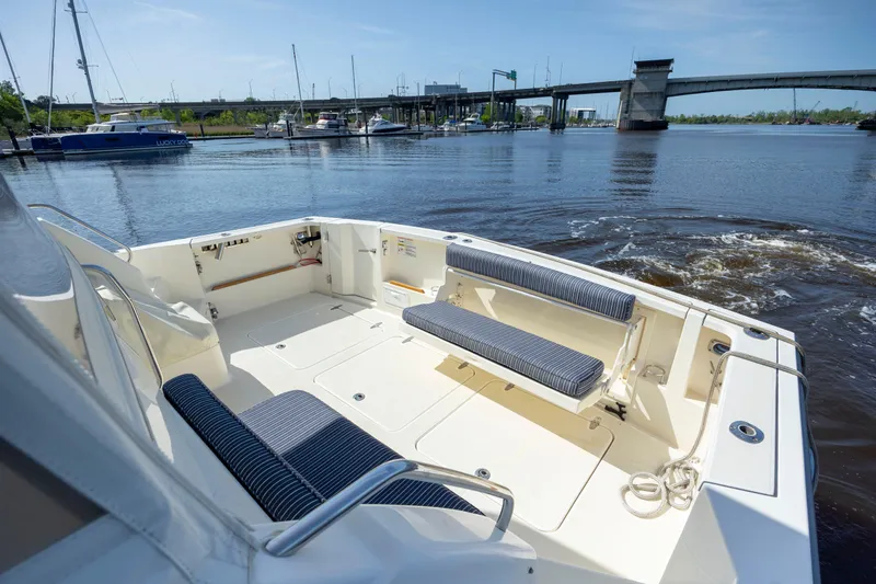  Yacht Photos Pics 2009 Sabre 42 Express boat deck with seating, overlooking marina and bridge.
