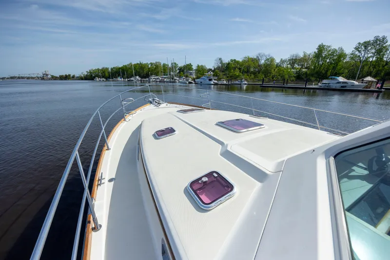  Yacht Photos Pics 2009 Sabre 42 Express yacht on calm water, showcasing deck and scenic marina view.