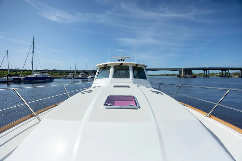  Yacht Photos Pics 2009 Sabre 42 Express yacht docked in a serene marina setting.