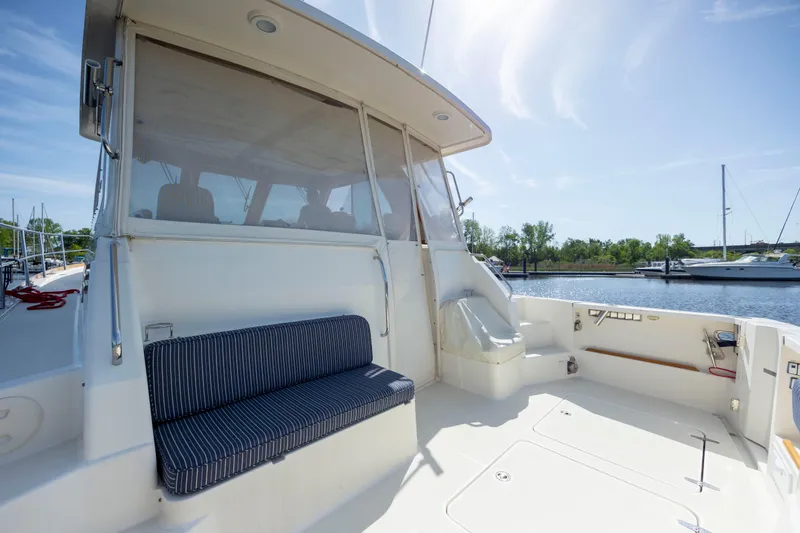  Yacht Photos Pics 2009 Sabre 42 Express yacht deck with seating, docked by calm waters.