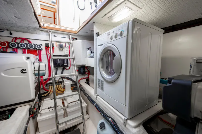  Yacht Photos Pics Laundry area inside 2009 Sabre 42 Express yacht, featuring a washing machine and utility equipment.