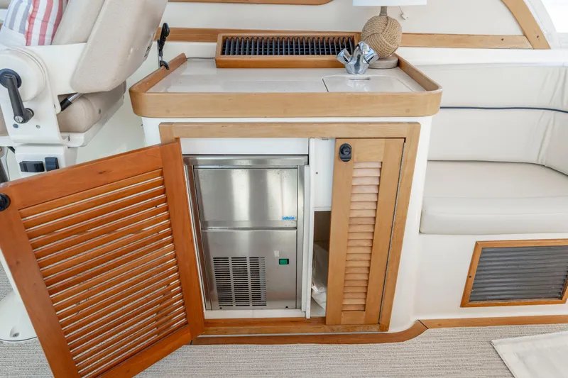  Yacht Photos Pics 2009 Sabre 42 Express yacht interior with open wooden cabinet and stainless steel appliance.