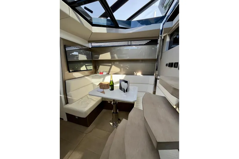 Celebrate Life Yacht Photos Pics Luxurious interior of 2021 Steeler Bronson 50 yacht with elegant seating and table.