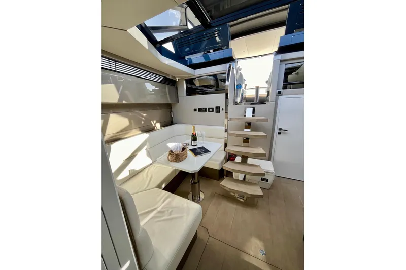 Celebrate Life Yacht Photos Pics Luxurious interior of 2021 Steeler Bronson 50 yacht with modern seating and staircase.