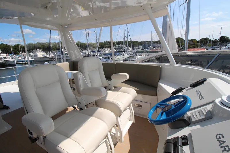 Build To Order Yacht Photos Pics Luxurious helm of 2026 Chris White Spindrift 47 yacht with plush seating and Garmin navigation.