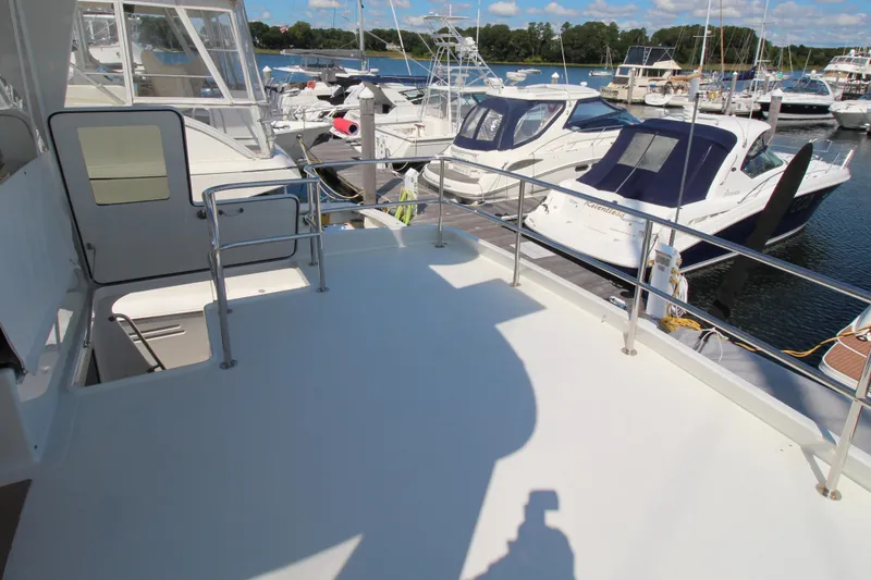 Build To Order Yacht Photos Pics Deck view of 2026 Chris White Spindrift 47 yacht in marina, surrounded by boats.