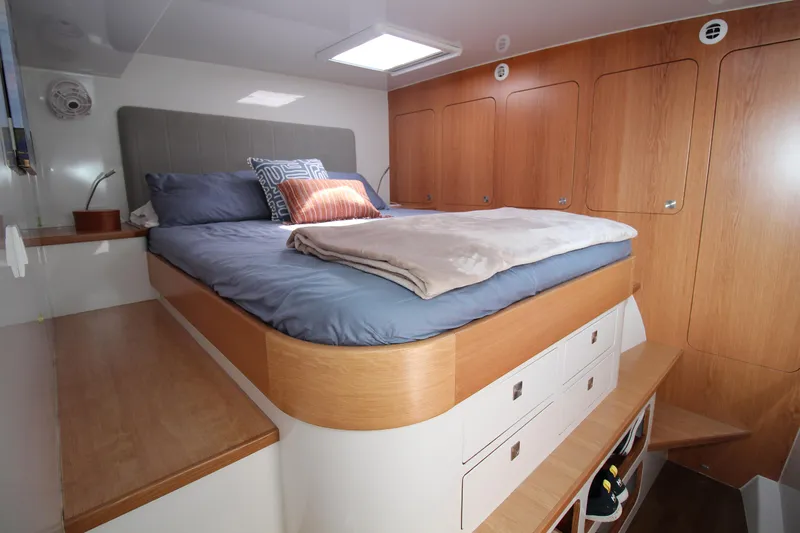 Build To Order Yacht Photos Pics Luxurious cabin interior of 2026 Chris White Spindrift 47 yacht with cozy bed and wooden storage.