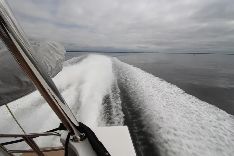 Build To Order Yacht Photos Pics Chris White Spindrift 47 (2026) cruising, leaving a foamy wake on calm waters.