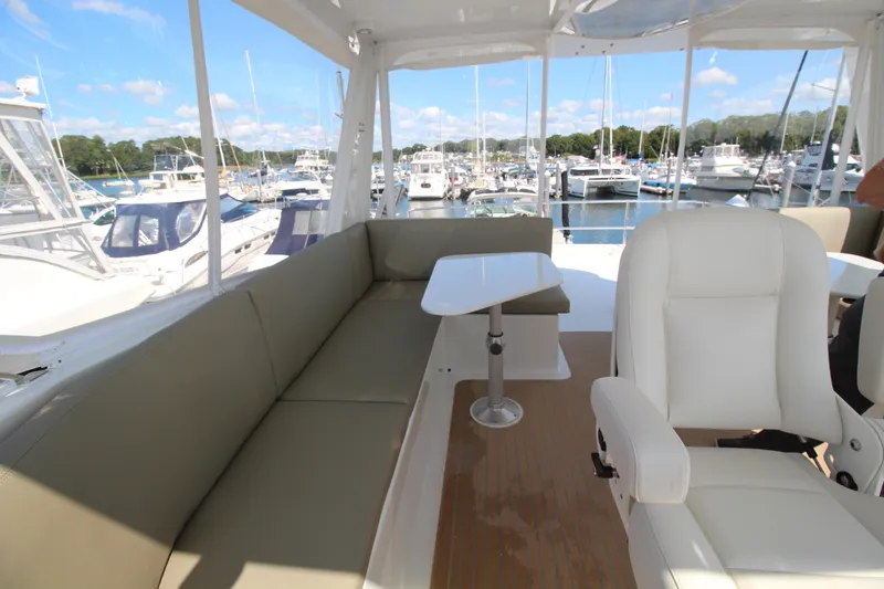 Build To Order Yacht Photos Pics Luxurious seating area on 2026 Chris White Spindrift 47 yacht, docked at marina.