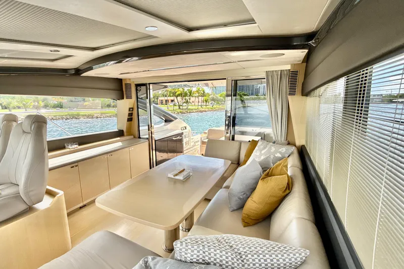 Il Capo Yacht Photos Pics Luxurious interior of 2017 Princess V58 yacht with elegant seating and scenic water view.