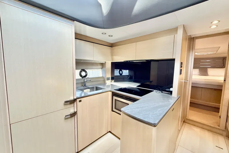 Il Capo Yacht Photos Pics Modern kitchen interior of 2017 Princess V58 yacht with sleek cabinetry and appliances.