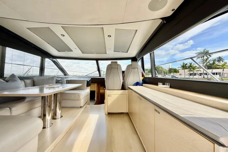 Il Capo Yacht Photos Pics Luxurious interior of 2017 Princess V58 yacht with modern seating and panoramic windows.