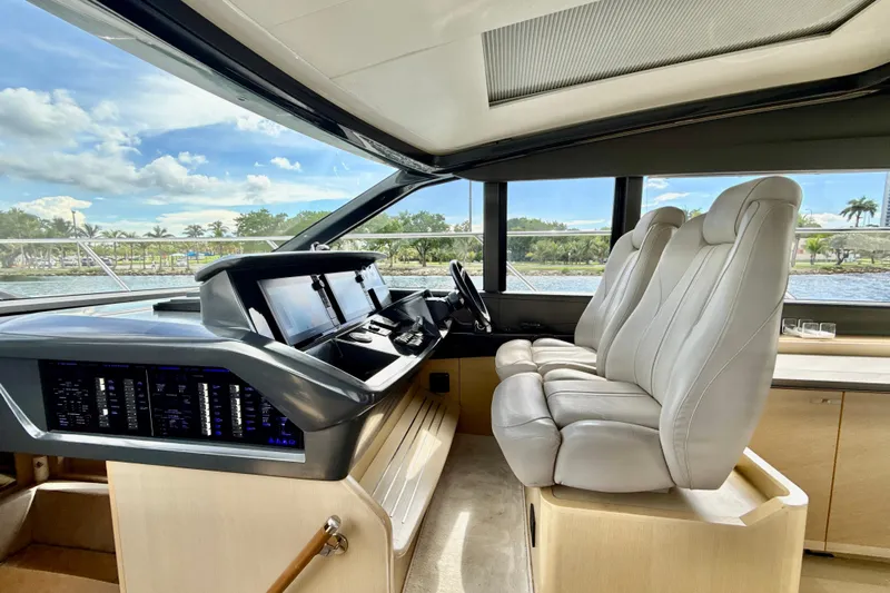 Il Capo Yacht Photos Pics Luxurious interior of 2017 Princess V58 yacht with modern helm and plush seating.