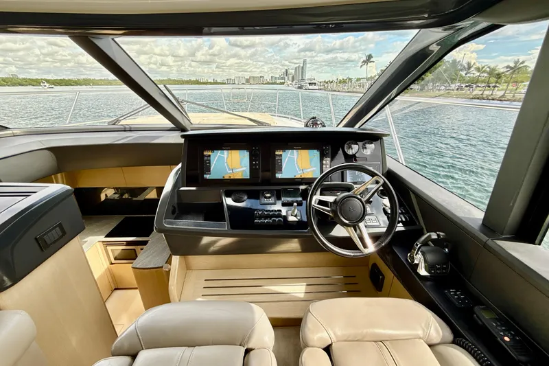 Il Capo Yacht Photos Pics Interior view of 2017 Princess V58 yacht cockpit with navigation screens and steering wheel.