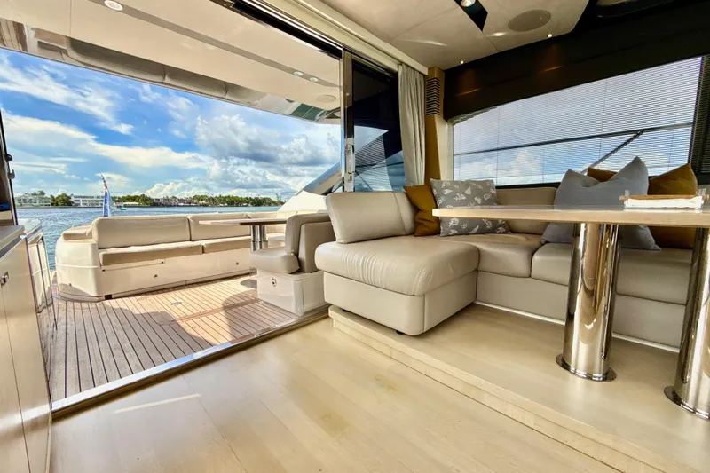 Il Capo Yacht Photos Pics Luxurious interior of 2017 Princess V58 yacht with elegant seating and scenic water view.