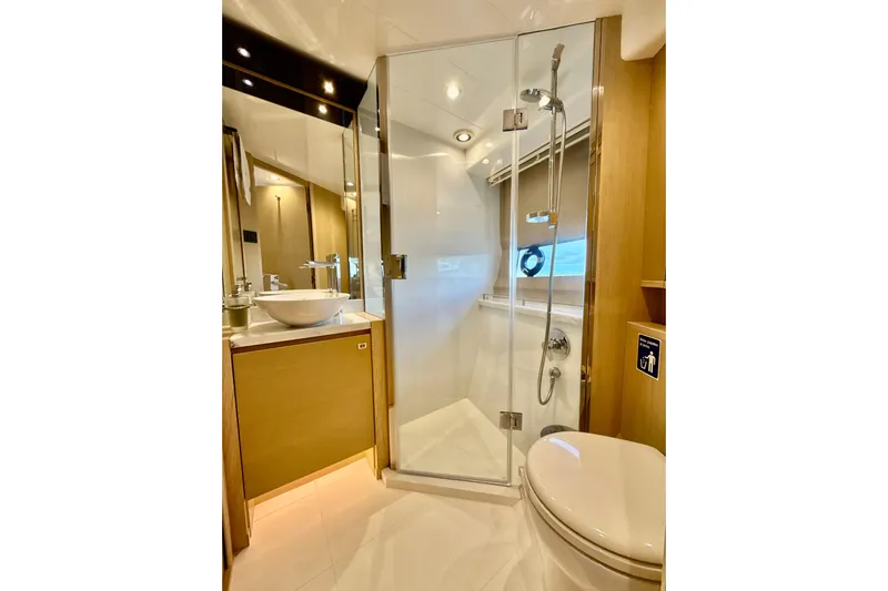 Il Capo Yacht Photos Pics Luxurious bathroom in 2017 Princess V58 yacht with glass shower and modern fixtures.