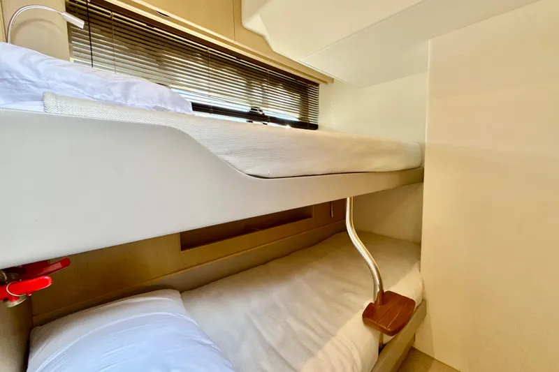 Il Capo Yacht Photos Pics Bunk beds in 2017 Princess V58 yacht cabin, featuring modern design and cozy bedding.