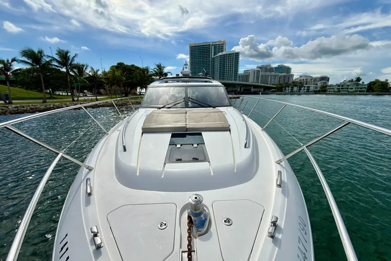 Il Capo Yacht Photos Pics 2017 Princess V58 yacht cruising near city skyline and palm trees.