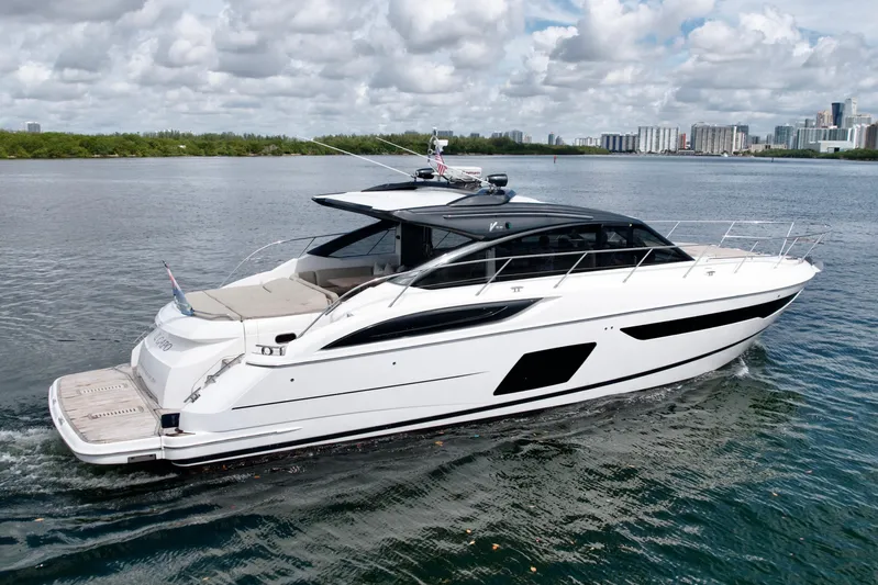 Il Capo Yacht Photos Pics 2017 Princess V58 yacht cruising on a calm waterway under a partly cloudy sky.