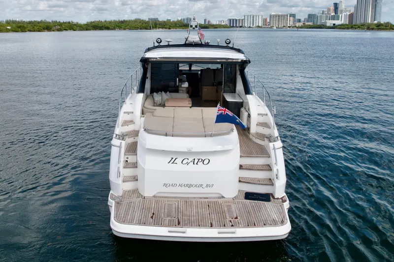Il Capo Yacht Photos Pics 2017 Princess V58 yacht "IL CAPO" on water, rear view with flag, city skyline.