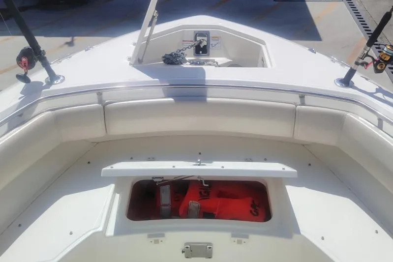  Yacht Photos Pics 2024 Boston Whaler 280 Outrage boat interior with storage compartment and fishing rods.