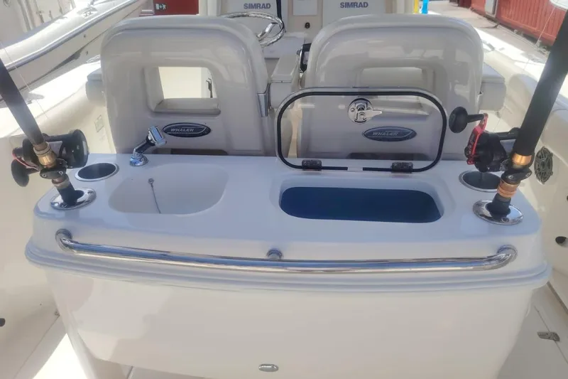  Yacht Photos Pics 2024 Boston Whaler 280 Outrage fishing station with rod holders and storage compartments.