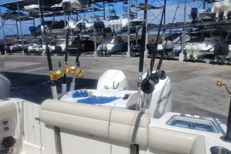 Yacht Photos Pics 2024 Boston Whaler 280 Outrage with fishing rods, docked at a marina.